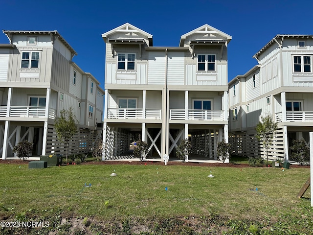 back of property with a lawn