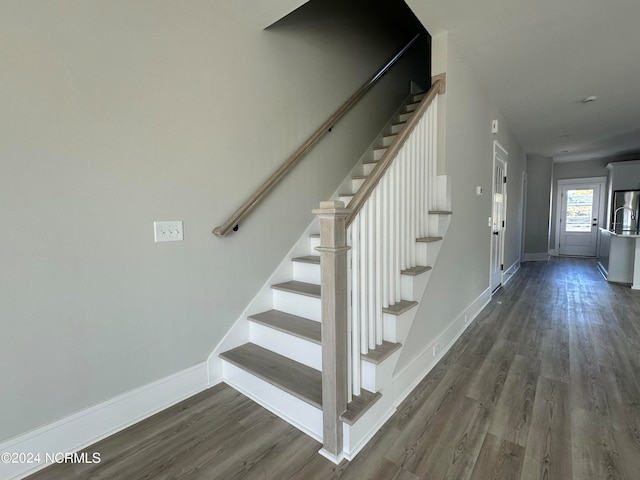 stairway with hardwood / wood-style flooring