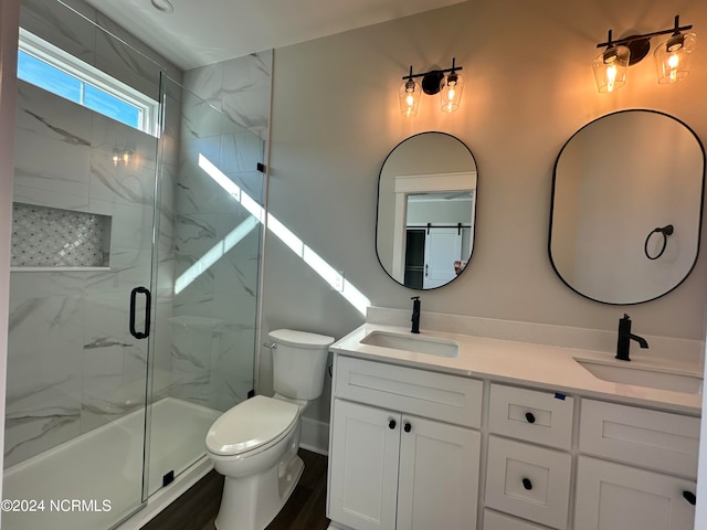 bathroom featuring a shower with door, vanity, toilet, and wood-type flooring