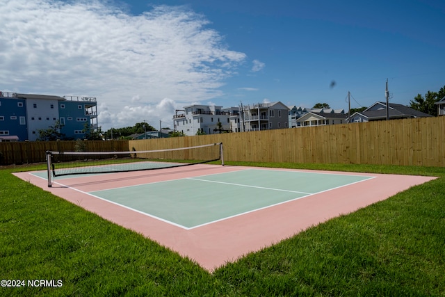 view of sport court featuring a yard and basketball court