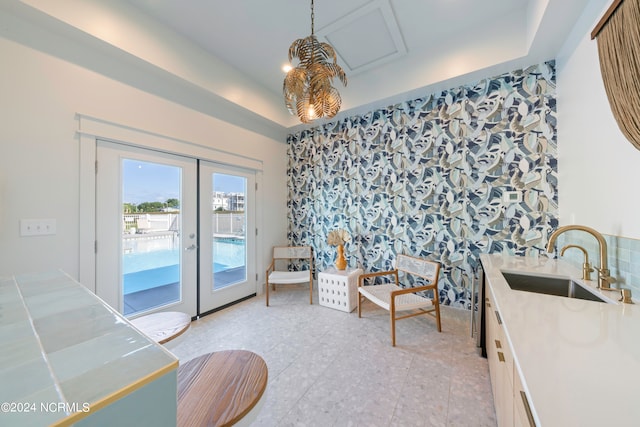 interior space featuring french doors, light tile patterned flooring, and sink