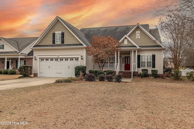 craftsman-style house with a yard, a garage, and covered porch