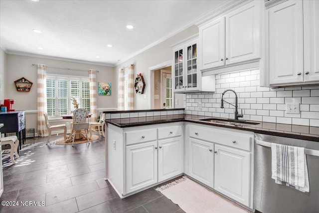 kitchen featuring white cabinets, a sink, and stainless steel dishwasher