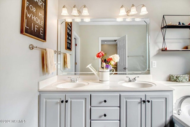 full bathroom with a sink, a bath, and double vanity