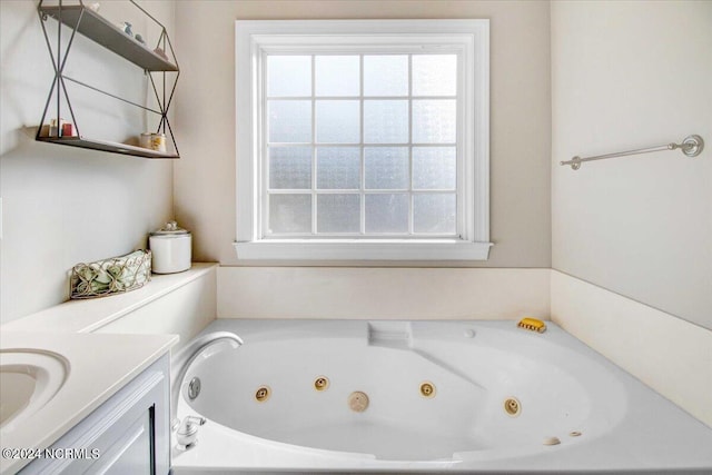 bathroom with a jetted tub and vanity