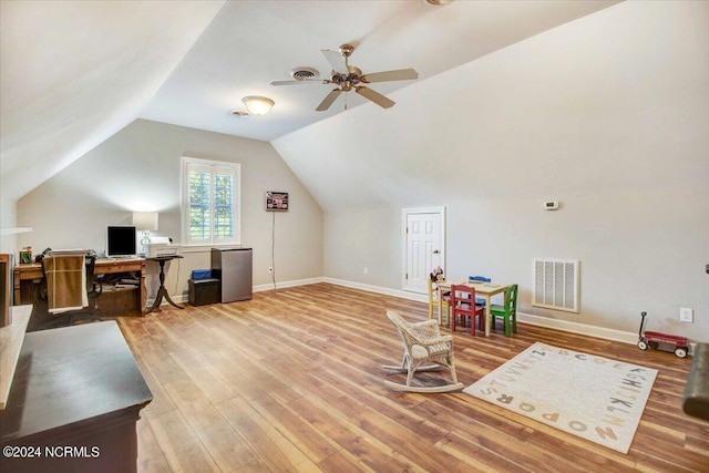 office with lofted ceiling, wood finished floors, visible vents, and baseboards