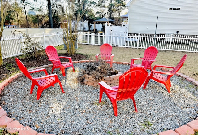 view of patio featuring a gazebo, an outdoor fire pit, and a fenced backyard