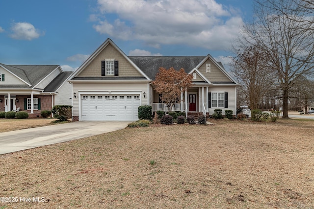 craftsman-style house with covered porch, driveway, a front yard, and a garage