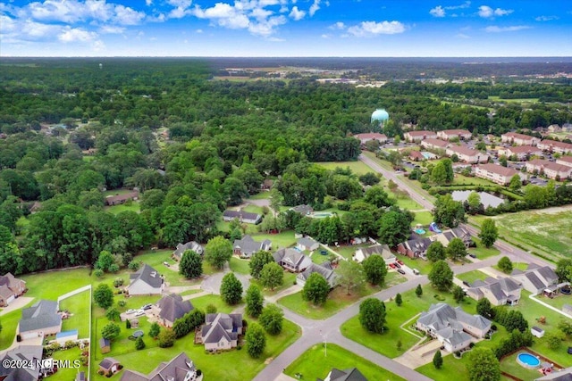 bird's eye view with a wooded view and a residential view