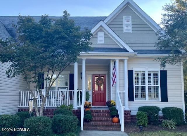 view of front of home featuring roof with shingles