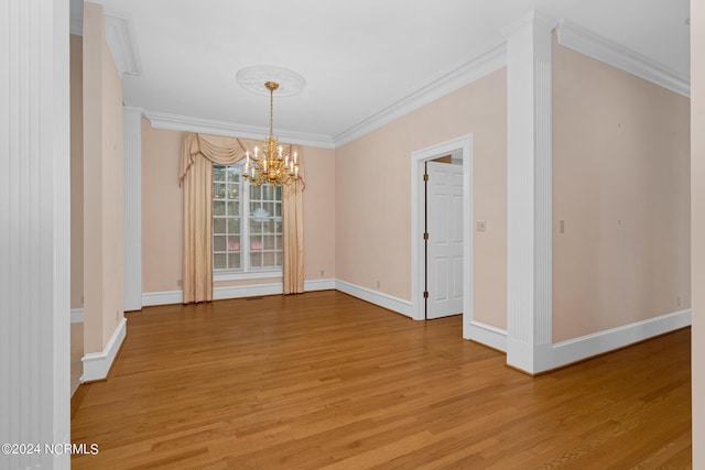 unfurnished dining area featuring crown molding, a chandelier, and hardwood / wood-style flooring