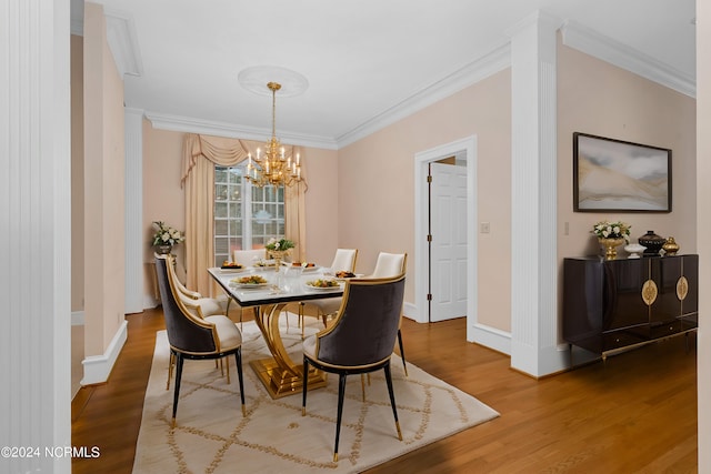 dining area featuring ornamental molding, hardwood / wood-style floors, and a notable chandelier