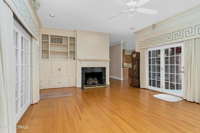 unfurnished living room featuring crown molding, ceiling fan, and light hardwood / wood-style flooring