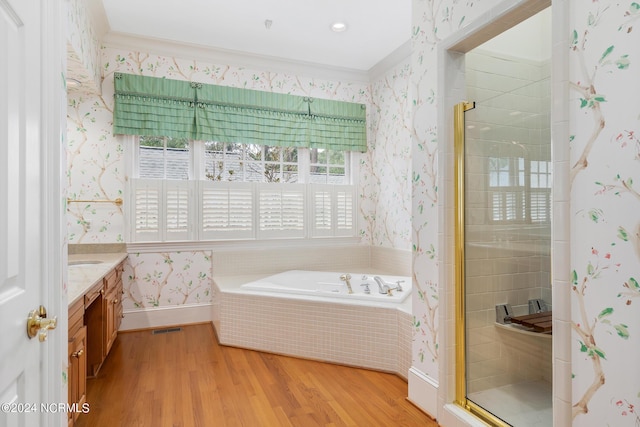 bathroom featuring hardwood / wood-style flooring, vanity, shower with separate bathtub, and crown molding