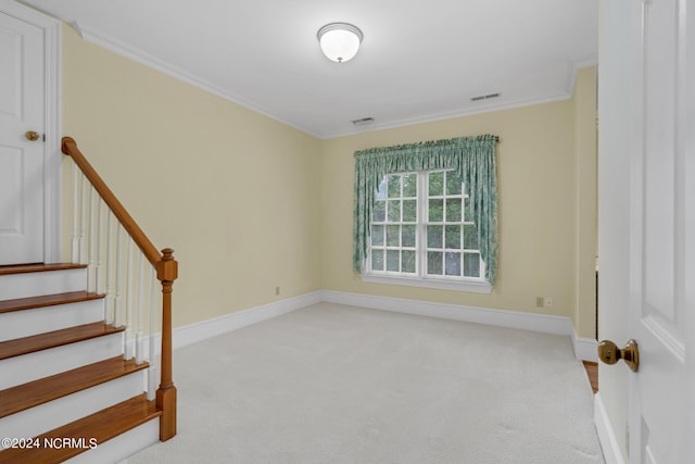 interior space with crown molding and light carpet