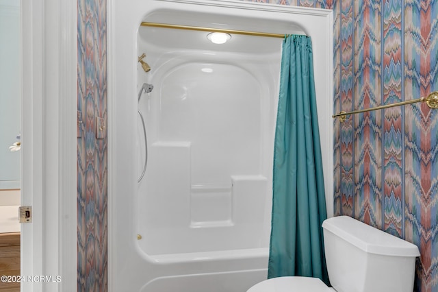 bathroom with shower / bathtub combination with curtain and toilet