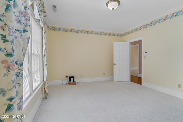 carpeted spare room featuring ornamental molding