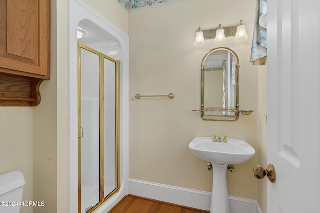 bathroom with wood-type flooring and toilet