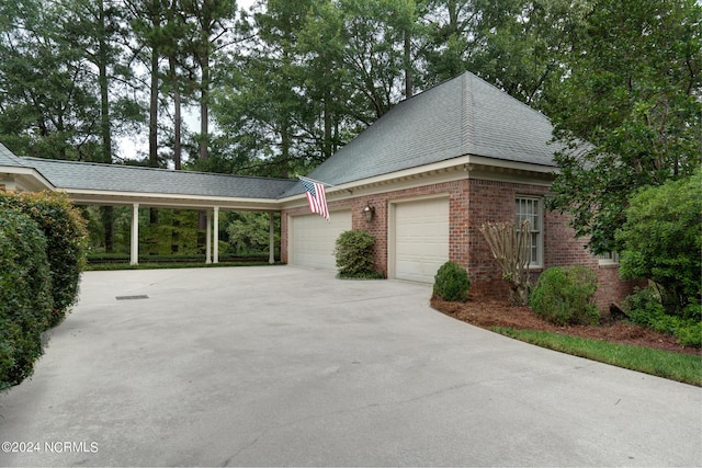 view of home's exterior with a carport and a garage