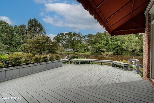 wooden terrace featuring a water view