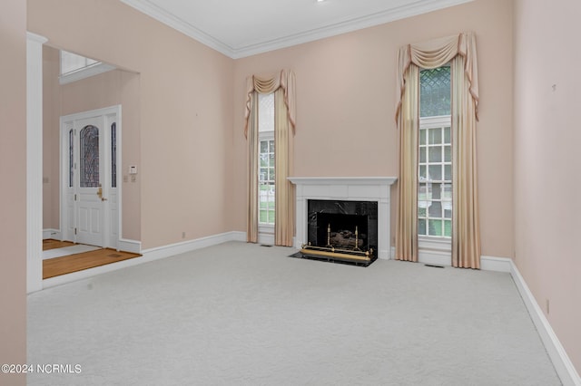 unfurnished living room featuring a high end fireplace, ornamental molding, and carpet flooring