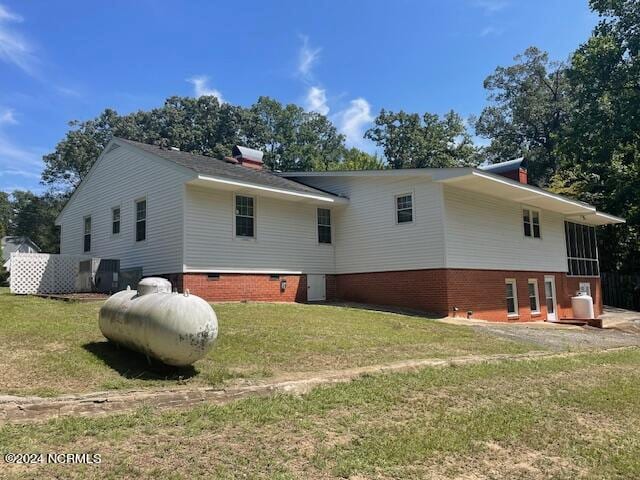 back of property featuring a yard