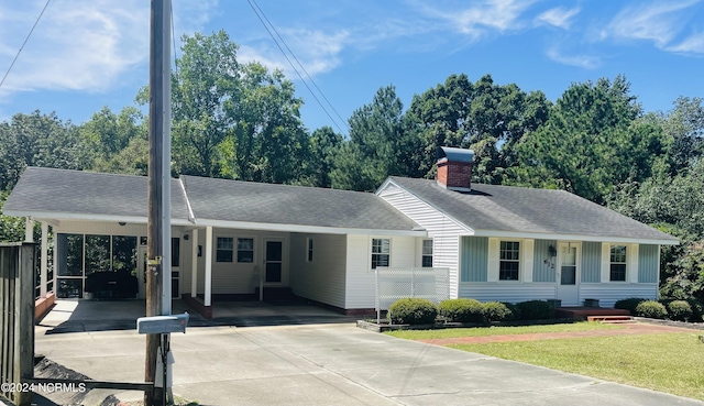 612 David St, Elizabethtown, NC 28337 - ranch-style home featuring driveway, a carport, a chimney, roof with shingles, and a front yard