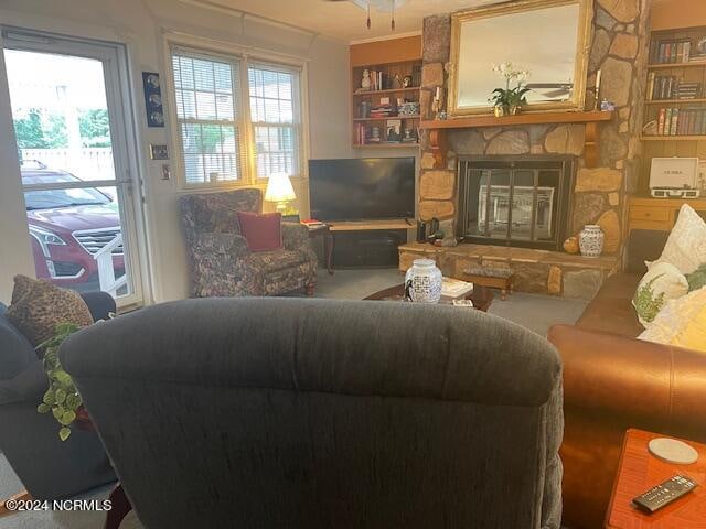 living room featuring a stone fireplace