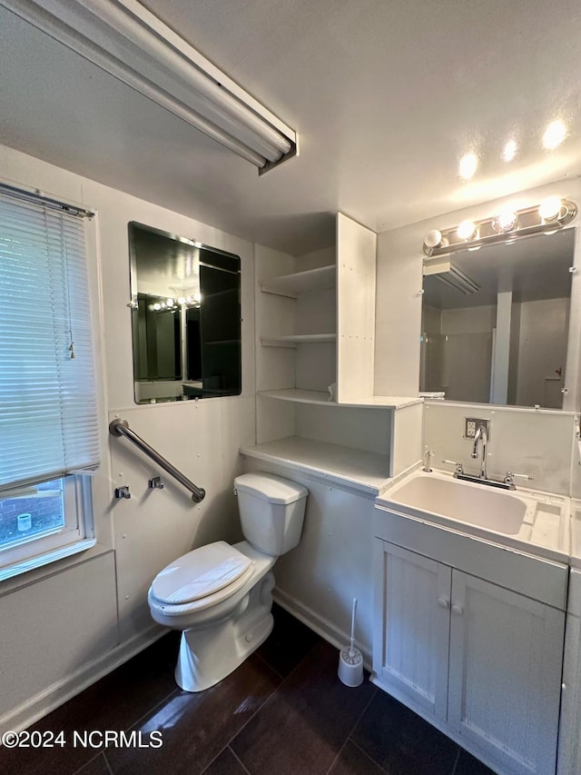 bathroom featuring vanity, toilet, and tile patterned floors