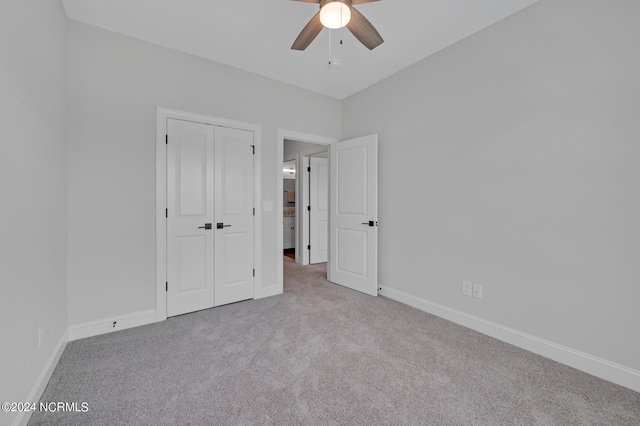 unfurnished bedroom with a closet, ceiling fan, and light carpet