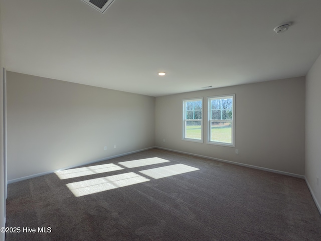 carpeted empty room with baseboards and visible vents