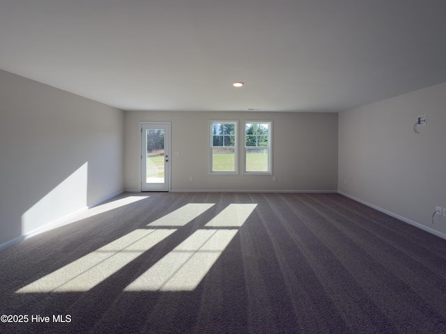 carpeted empty room with baseboards