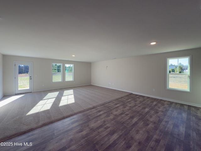 empty room with recessed lighting, baseboards, and dark wood finished floors