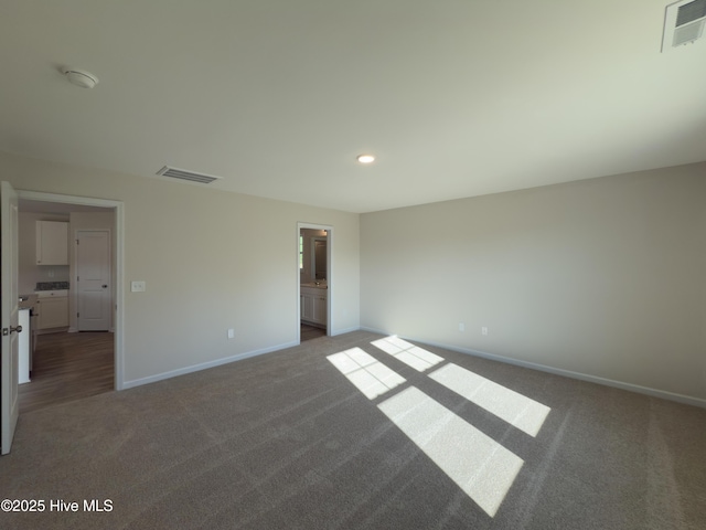 unfurnished bedroom with visible vents, baseboards, and carpet