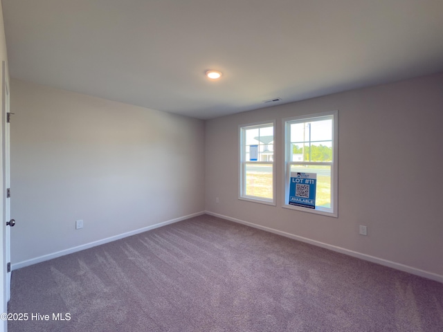 carpeted empty room with baseboards and visible vents