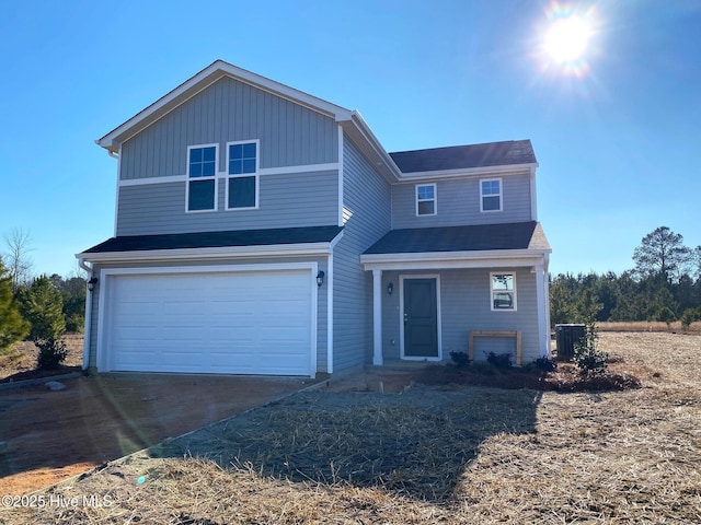 front of property with a garage and central air condition unit