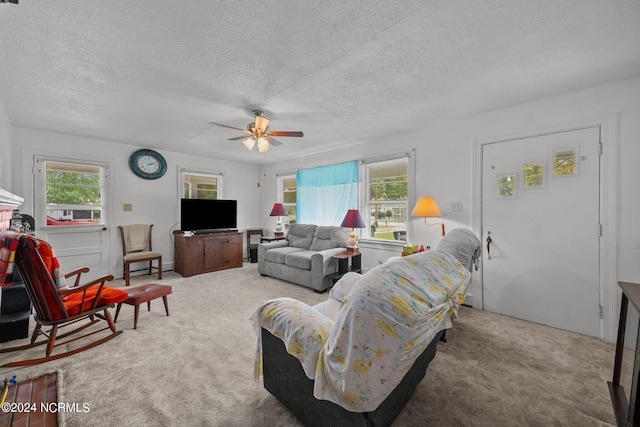 living room with a healthy amount of sunlight, ceiling fan, and carpet