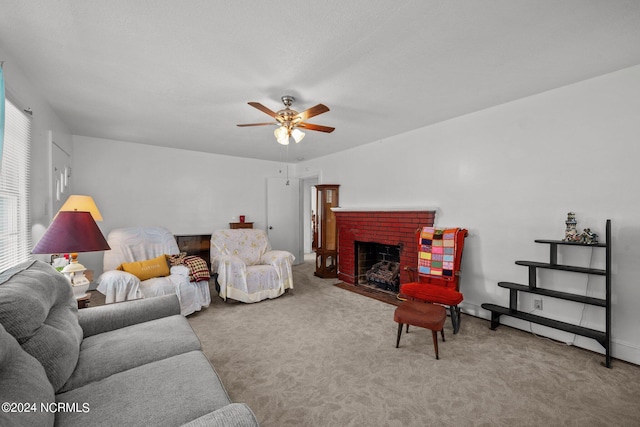 carpeted living room featuring ceiling fan and a fireplace