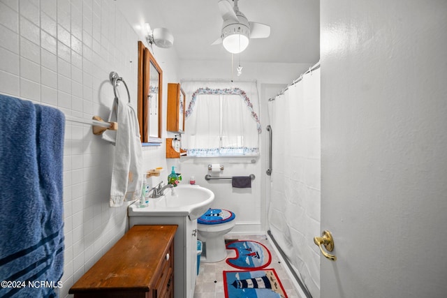 bathroom featuring curtained shower, toilet, tile walls, ceiling fan, and vanity