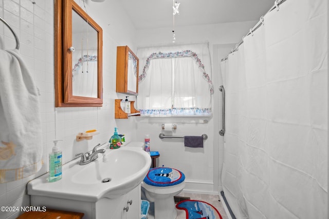 bathroom with tile walls, toilet, and vanity