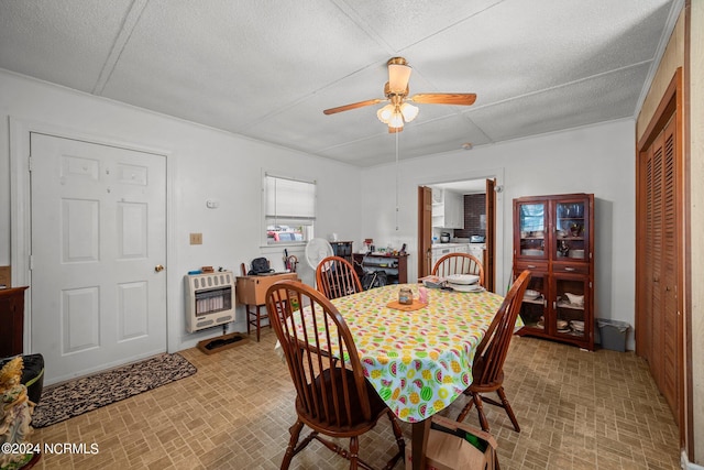 dining area with ceiling fan, heating unit, and a textured ceiling