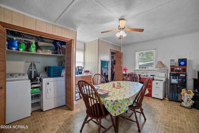 dining area featuring independent washer and dryer, ceiling fan, and wooden walls