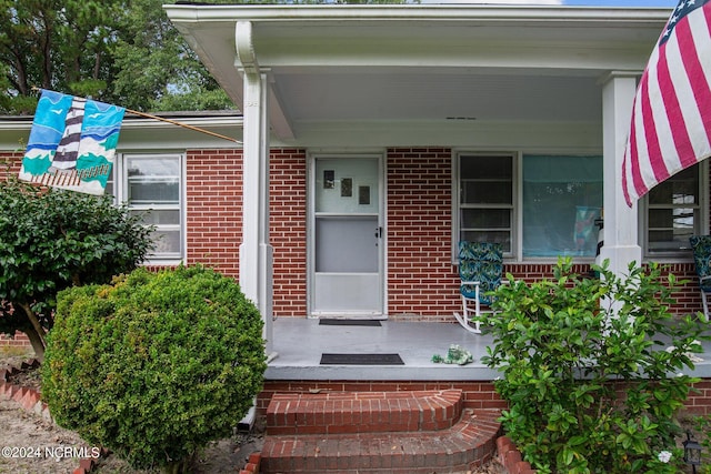 doorway to property with a porch