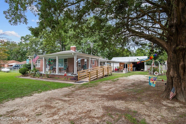 exterior space featuring a playground, covered porch, and a front yard