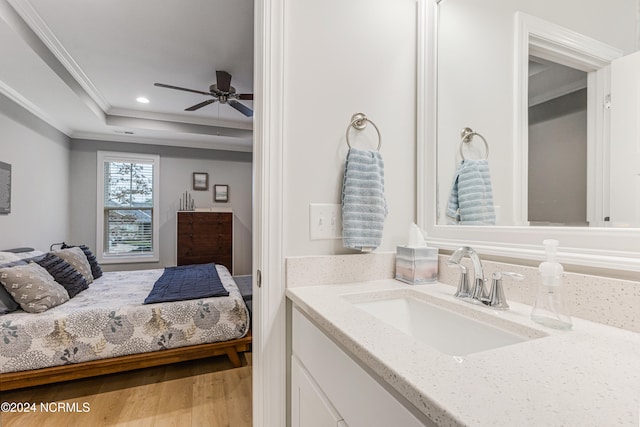 bathroom with vanity, crown molding, hardwood / wood-style flooring, and ceiling fan