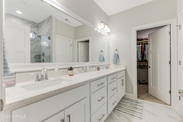 bathroom with a shower with door and vanity