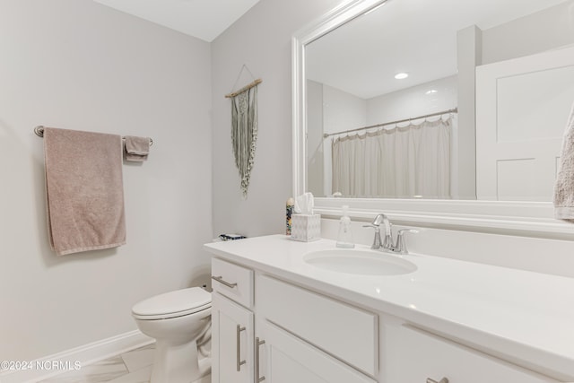 bathroom with vanity, a shower with shower curtain, and toilet