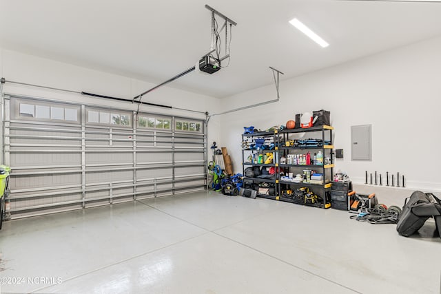 garage with a garage door opener and electric panel