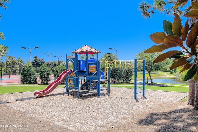 view of jungle gym featuring a water view