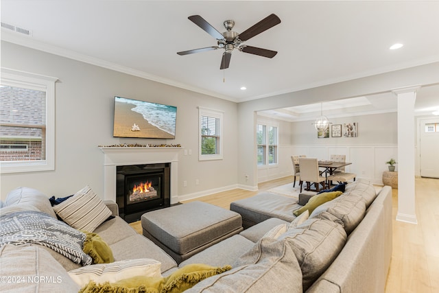 living room with ornamental molding, decorative columns, light hardwood / wood-style floors, and ceiling fan